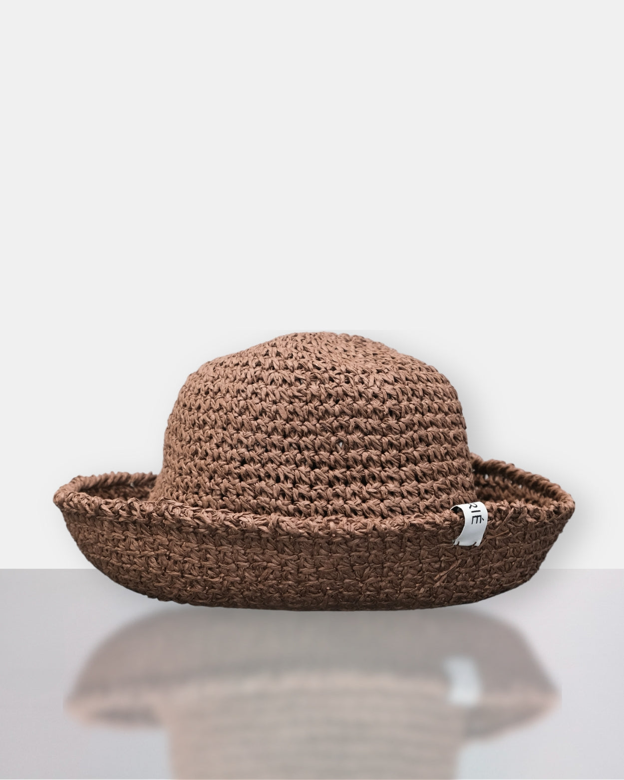 Brown woven hat on a white background